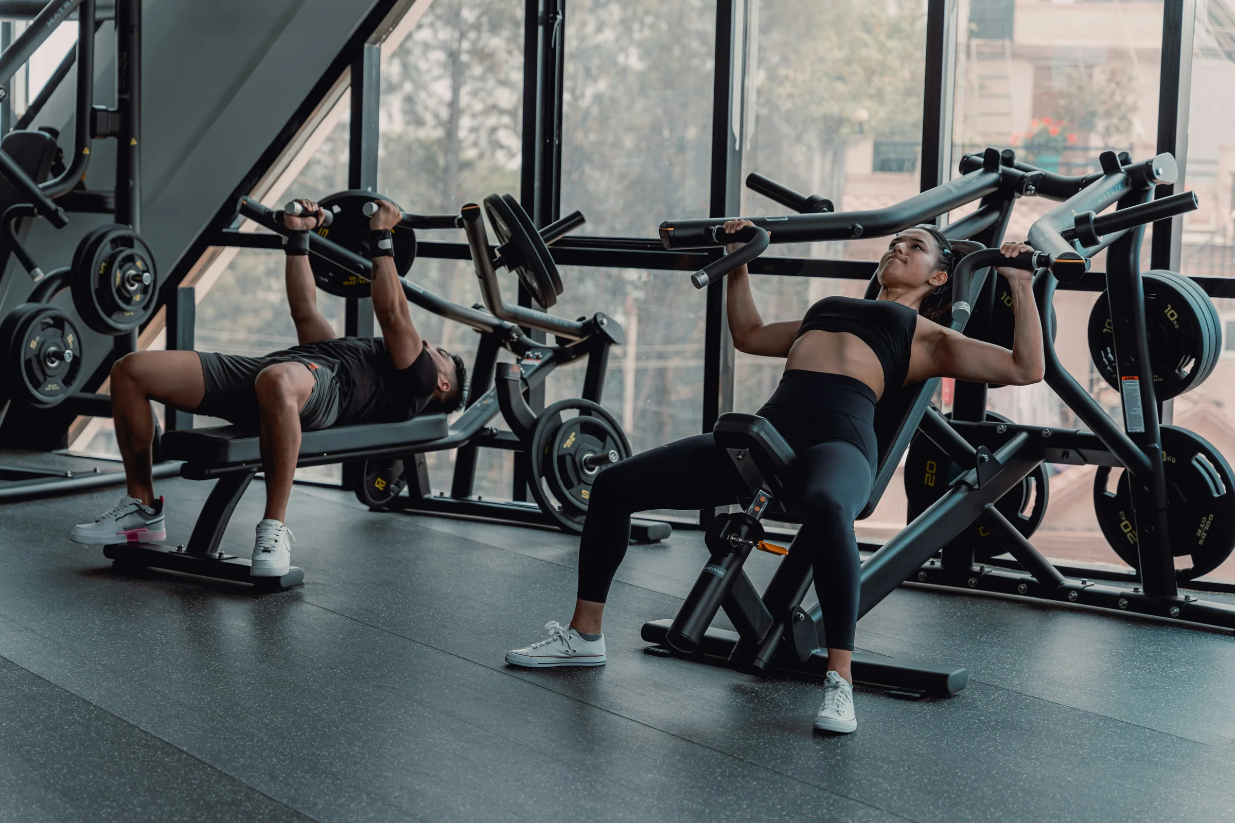The floor of a gym, racks and machines
